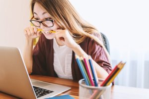 Girl biting pencil